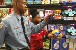 After their mini game of hoops, Officer Casey and Aniyah set off to look for a real basketball. (WTOP/Kristi King)