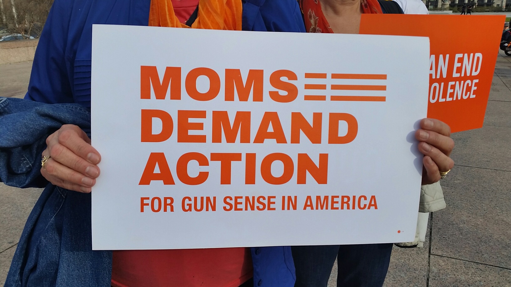 Local chapters of the Moms Demand Action for Gun Sense in America led an "Orange Walk' from Freedom Plaza to the White House on Sunday, Dec. 13, 2015, nearly three years since the massacre at Sandy Hook. Thousands of people nationwide participated in the Orange Walk movement nationwide. (WTOP/Kathy Stewart)