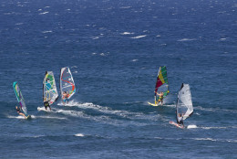 FILE - In this Jan. 2, 2014 file photo, windsurfers crowd the waters at Ho'okipa outlook, near Paia, Maui Hawaii. Maui is known for beautiful beaches and scenery.  (AP Photo/Marco Garcia, File)