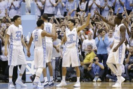 North Carolina's Marcus Paige (5) is congratulated by teammates from left, Justin Jackson (44), Joel Berry II (2) and Theo Pinson, right, following the team's 89-81 win over Maryland in an NCAA college basketball game in Chapel Hill, N.C., Tuesday, Dec. 1, 2015. (AP Photo/Gerry Broome)