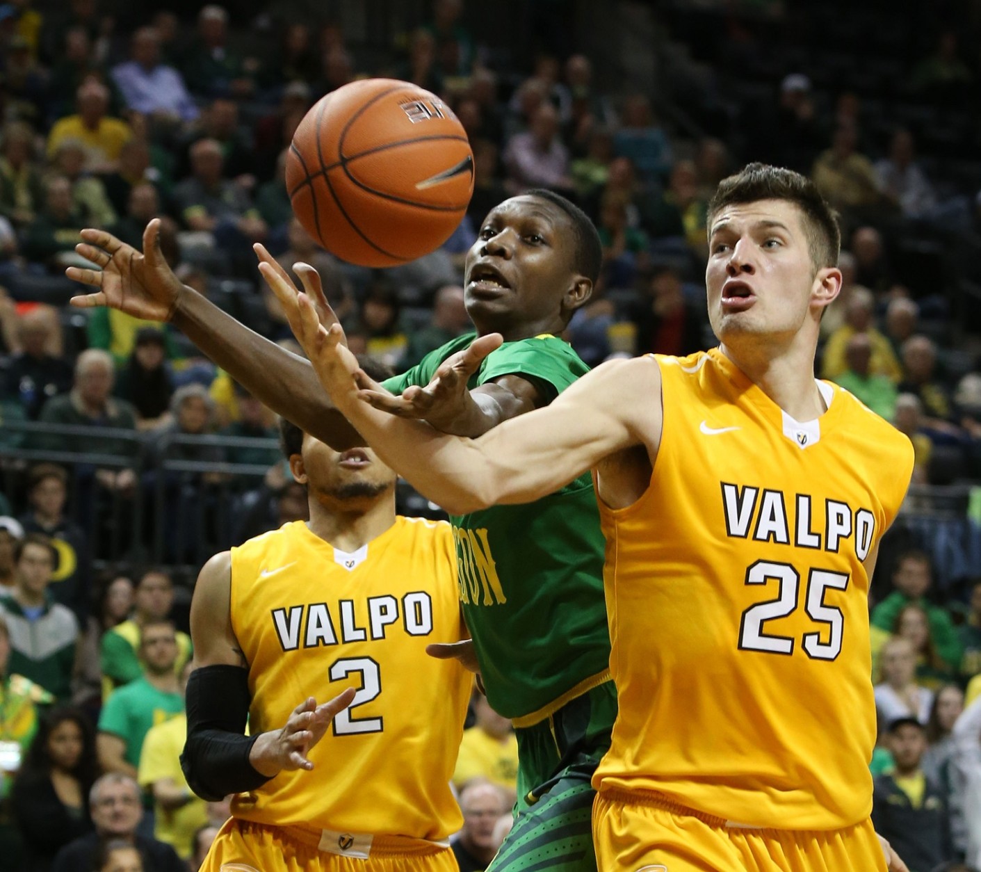 Valparaiso's Tevonn Walker, left, and Alec Peters, right, battle Oregon's Chris Boucher for a rebound during the second half of an NCAA college basketball game Sunday, Nov. 22, 2015, in Eugene, Ore. (AP Photo/Chris Pietsch)