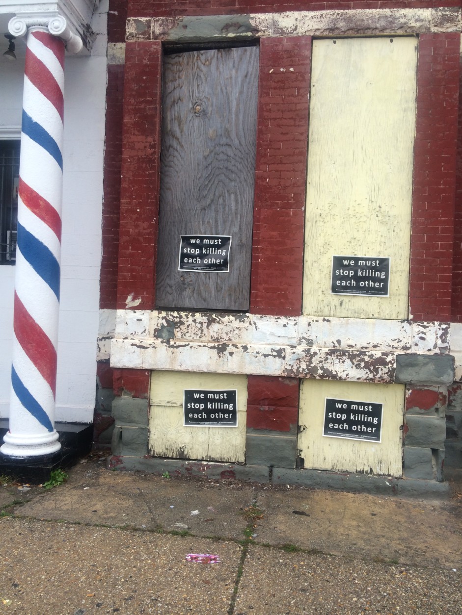 Boarded windows bear a message in Freddie Gray's neighborhood in West Baltimore. (WTOP/Dick Uliano)