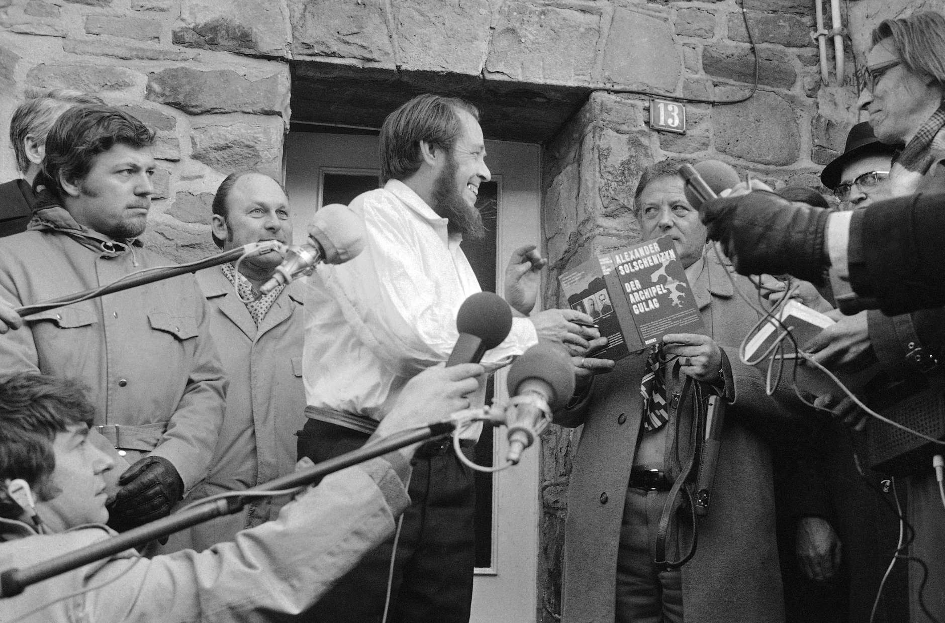 Expelled Soviet author and Nobel Prize winner Alexander Solzhenitsyn grabs for the book The Gulag Archipelago in Langenbroich on Feb. 14, 1974 when journalists and onlookers asked him to sign his book, which he had in hand in this Western country for the first time. (AP Photo/Pro)
