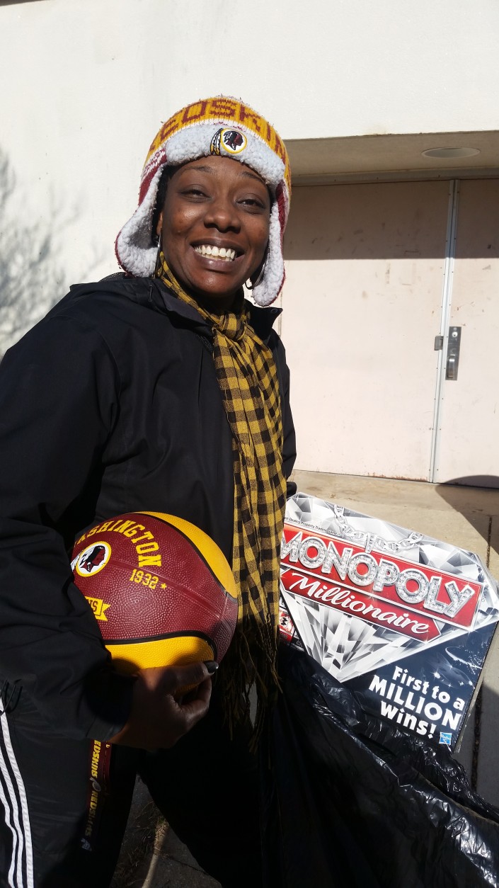Tiffany Burke found some of the gifts for her kids during the Toys for Tots event at Prince George’s County police headquarters on Saturday, Dec. 19, 2015. (WTOP/Allison Keyes)