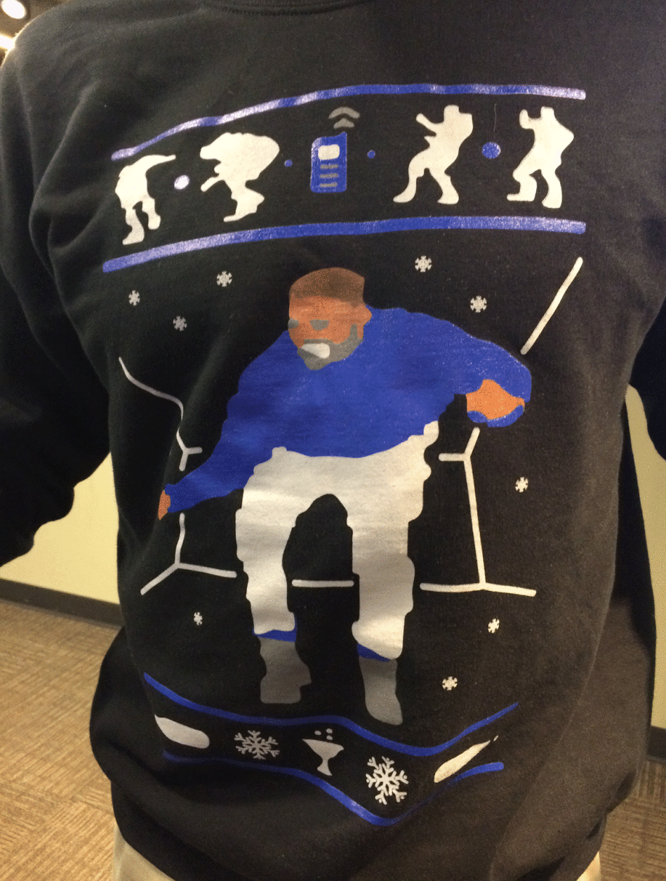WTOP's Web Editor Marcus J. Moore sports a holiday sweater -- this one with a Drake "Hotline Bling" theme. (WTOP/Sarah Beth Hensley)