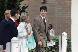 William Kennedy Smith, right, enters the Palm Beach County Courthouse in West Palm Beach, Dec. 2, 1991 with members of his family for the first day of his sexual assault trial. His mother Jean is in the center holding a newspaper. (AP Photo/Chris O'Meara)