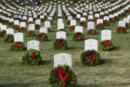 FILE -- Holiday wreaths adorn tombstones during Wreaths Across America's 25th anniversary, Saturday, Dec. 13, 2014, at Arlington National Cemetery in Arlington, Va. (AP Photo/Luis M. Alvarez)