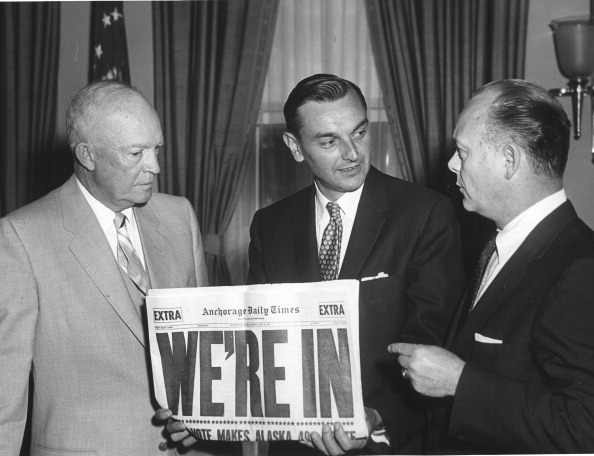 WIth a copy of Anchorage Daily News headlined 'We're In,' US President Dwight Eisenhower (1890 - 1965) poses with Governor of the Alaska Territories Mike Stepovich and Secretary of the Interior Fred Andrew Seaton (1909 - 1974) in the White House after Congress voted to approve Alaskas statehood, Washington DC, July 1, 1958. Alaska became the 49th state the following year. (Photo by Abbie Rowe/PhotoQuest/Getty Images)