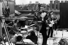 30th January 1969:  British rock group the Beatles performing their last live public concert on the rooftop of the Apple Organization building for director Michael Lindsey-Hogg's film documentary, 'Let It Be,' on Savile Row, London, England. Drummer Ringo Starr sits behind his kit. Singer/songwriters Paul McCartney and John Lennon perform at their microphones, and guitarist George Harrison (1943 - 2001) stands behind them. Lennon's wife Yoko Ono sits at right.  (Photo by Express/Express/Getty Images)
