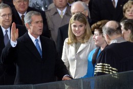 George W. Bush takes the oath of office from Chief Justice William Rehnquist to become the 43rd president Saturday, Jan. 20, 2001, in Washington. Wife Laura Bush holds the Bible and daughter Jenna watches. (AP Photo/Doug Mills)