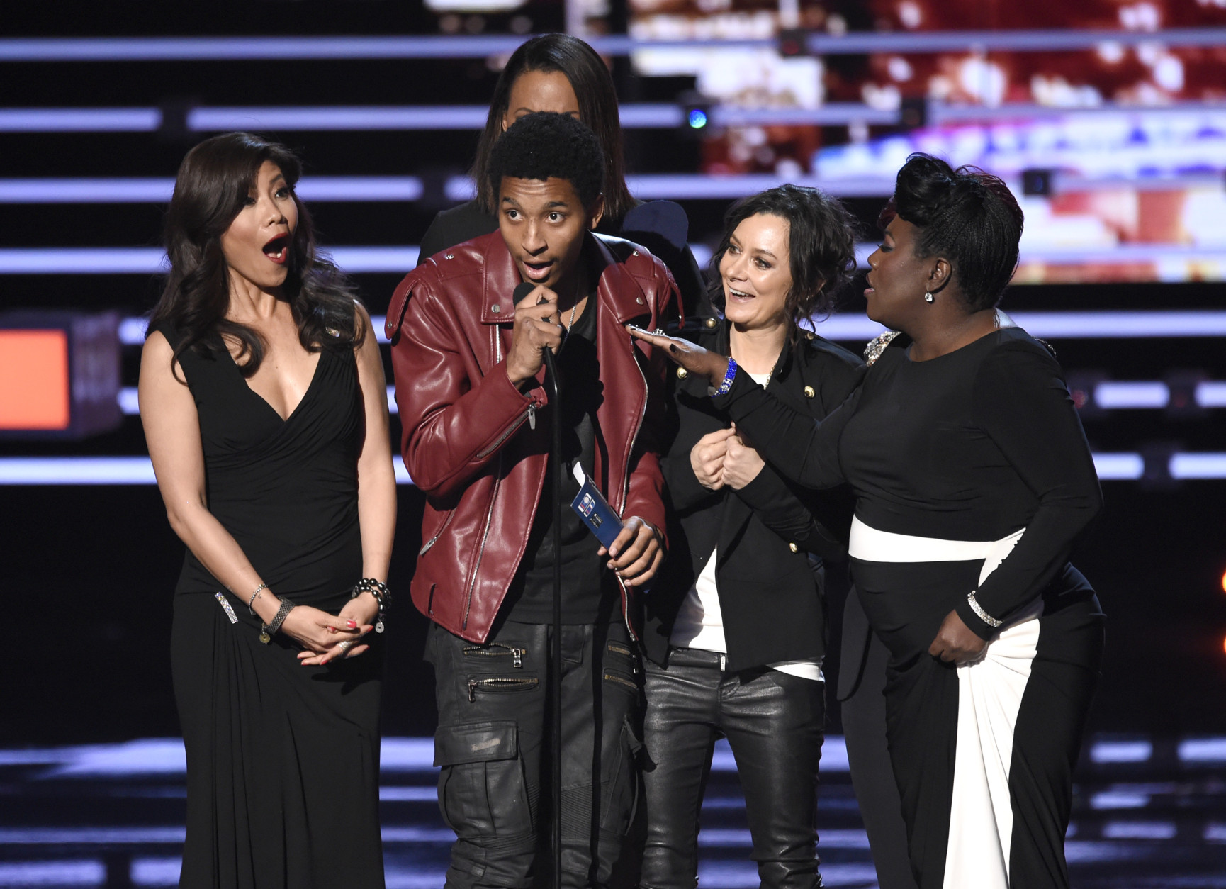 An unidentified guest speaks on stage while Julie Chen, Aisha Tyler, and Sheryl Underwood accept the award for favorite daytime TV hosting team for The Talk at the People's Choice Awards at the Microsoft Theater on Wednesday, Jan. 6, 2016, in Los Angeles. (Photo by Chris Pizzello/Invision/AP)