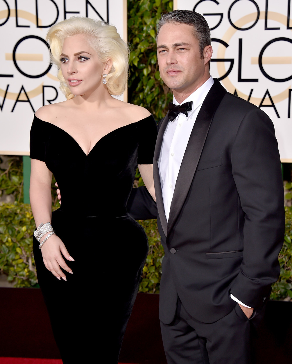 Lady Gaga, left, and Taylor Kinney arrive at the 73rd annual Golden Globe Awards on Sunday, Jan. 10, 2016, at the Beverly Hilton Hotel in Beverly Hills, Calif. (Photo by Jordan Strauss/Invision/AP)