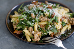This Jan. 4, 2011 photo shows spicy sausage and arugula penne in Concord, N.H. This recipe uses parmesan cheese, but an aged gouda or crumbled feta would be delicious, too.     (AP Photo/Matthew Mead)