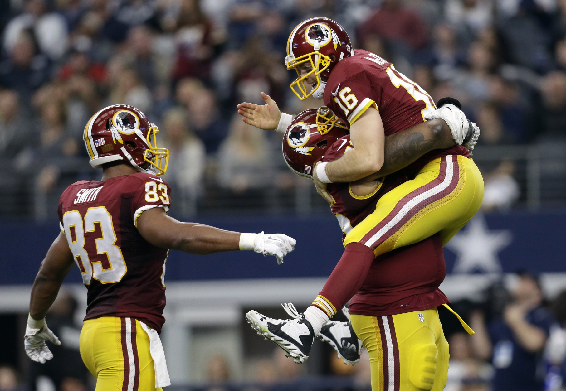 Washington Redskins' Alex Smith (83) and Spencer Long, carrying Colt McCoy (16), celebrate a long pass caught by Rashad Ross for a touchdown in the second half of an NFL football game against the Dallas Cowboys, Sunday, Jan. 3, 2016, in Arlington, Texas. (AP Photo/Tim Sharp)