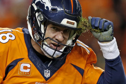 Denver Broncos quarterback Peyton Manning pulls grass off his helmet during the second half in an NFL football game against the San Diego Chargers, Sunday, Jan. 3, 2016, in Denver. (AP Photo/David Zalubowski)