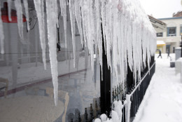 Icicles hang from a business Saturday, Jan. 23, 2016 in the Georgetown area of Washington. A blizzard with hurricane-force winds brought much of the East Coast to a standstill Saturday, dumping as much as 3 feet of snow, stranding tens of thousands of travelers and shutting down the nation's capital and its largest city. (AP Photo/Alex Brandon)