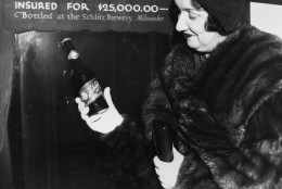 Rae Samuels holds the last bottle of beer that was distilled before prohibition went into effect in Chicago, Ill., Dec. 29, 1930.  The bottle of Schlitz has been insured for $25,000.  (AP Photo)