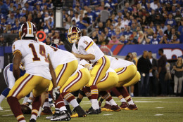 Washington Redskins quarterback Kirk Cousins (8) looks over his offensive line during the first half an NFL football game against the New York Giants Thursday Sept. 24, 2015, in East Rutherford, N.J. (AP Photo/Kathy Willens)