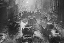 Fire engines make the debris in a London street, on Jan. 1, 1941. While playing hoses from these engines on to the many fires during the great fire-blitz on Sunday night these fire engines were themselves encircled by the flames and had to be abandoned. Some of London's heroic firefighters are seen in this picture examining their burnt-out apparatus. (AP Photo)
