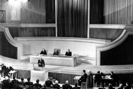 This is a general view of the first session of the United Nations Organization's General Assembly at Central Hall on Parliament Square in London, England, on January 10, 1946.  In his opening session address British Prime Minister Clement R. Attlee, on speaker's platform, warned that another war would destroy mankind. In the background is the U.N. emblem, the world surrounded by olive wreaths.  (AP Photo)