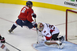Ottawa Senators goalie Andrew Hammond (30) saves the puck from going in the goal on a play by Washington Capitals left wing Alex Ovechkin (8), of Russia, during the second period of a NHL hockey game in at the Verizon Center in Washington, Sunday, Jan. 10, 2016. (AP Photo/Jacquelyn Martin)