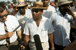 Dr. Martin Luther King Jr., center, speaks to reporters as he leads the 220 mile Memphis to Jackson march started by James Meredith, in a rural part of Mississippi, June 13, 1966. King and other civil rights leaders decided to continue the march after original leader, James Meredith, was shot and wounded shortly after starting out. (AP Photo)