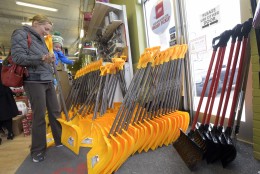 Bethany Gallagher, of Baltimore, shops for a snow shovel with her 18-month-old son, Jack, at the Waverly Ace Hardware store, in Baltimore, Friday, Jan. 22, 2016. The northern mid-Atlantic region, including Baltimore, Washington and Philadelphia, is preparing for a weekend snowstorm that is now forecast to reach blizzard conditions. (AP Photo/Steve Ruark)