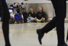 Tracey Shelton, left, Paige Willey, center, and Warren Willey, right, of Crisfield, Md., wait to reschedule a flight at Miami International Airport, as their flight to Baltimore was canceled, Friday, Jan. 22, 2016, in Miami. Airlines have canceled more than 2,700 flights Friday to, from or within the U.S., as a blizzard swings up the East Coast, according to flight tracking service FlightAware. (AP Photo/Lynne Sladky)