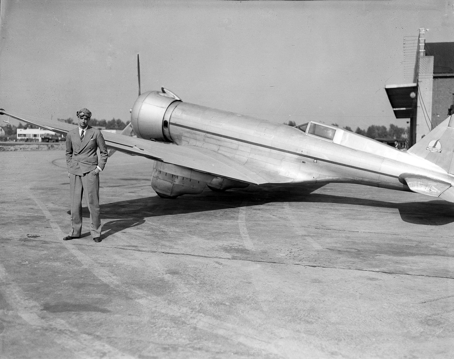 Millionaire sportsman, movie producer and holder of flight speed records Howard Hughes, poses by his air speedster shortly before roaring westward to Los Angeles, from Chicago, Ill., May 14, 1936, in an effort set a "lunch-to-dinner" air record. Inspired by a $50 bet, he had lunch in Chicago, then was off in an effort to reach Los Angeles in time for dinner. (AP Photo)