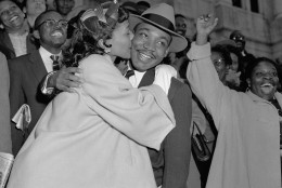 The Rev. Martin Luther King Jr. is welcomed with a kiss by his wife Coretta after leaving court in Montgomery, Ala., March 22, 1956. King was found guilty of conspiracy to boycott city buses in a campaign to desegregate the bus system, but a judge suspended his $500 fine pending appeal. (AP Photo/Gene Herrick)