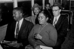 Two black ministers who were active in the long boycott of segregated buses were among the first to ride, December 21, 1956, after the Supreme Court's integration order went into effect in Montgomery, Ala.  At left, front seat, is the Rev. Ralph D. Abernathy.  At left, second seat, is the Rev. Martin Luther King, Jr., and at the right is a white minister, the Rev. Glenn Smiley of New York, who said he was in Montgomery as an observer.  The woman is unidentified.  (AP Photo)