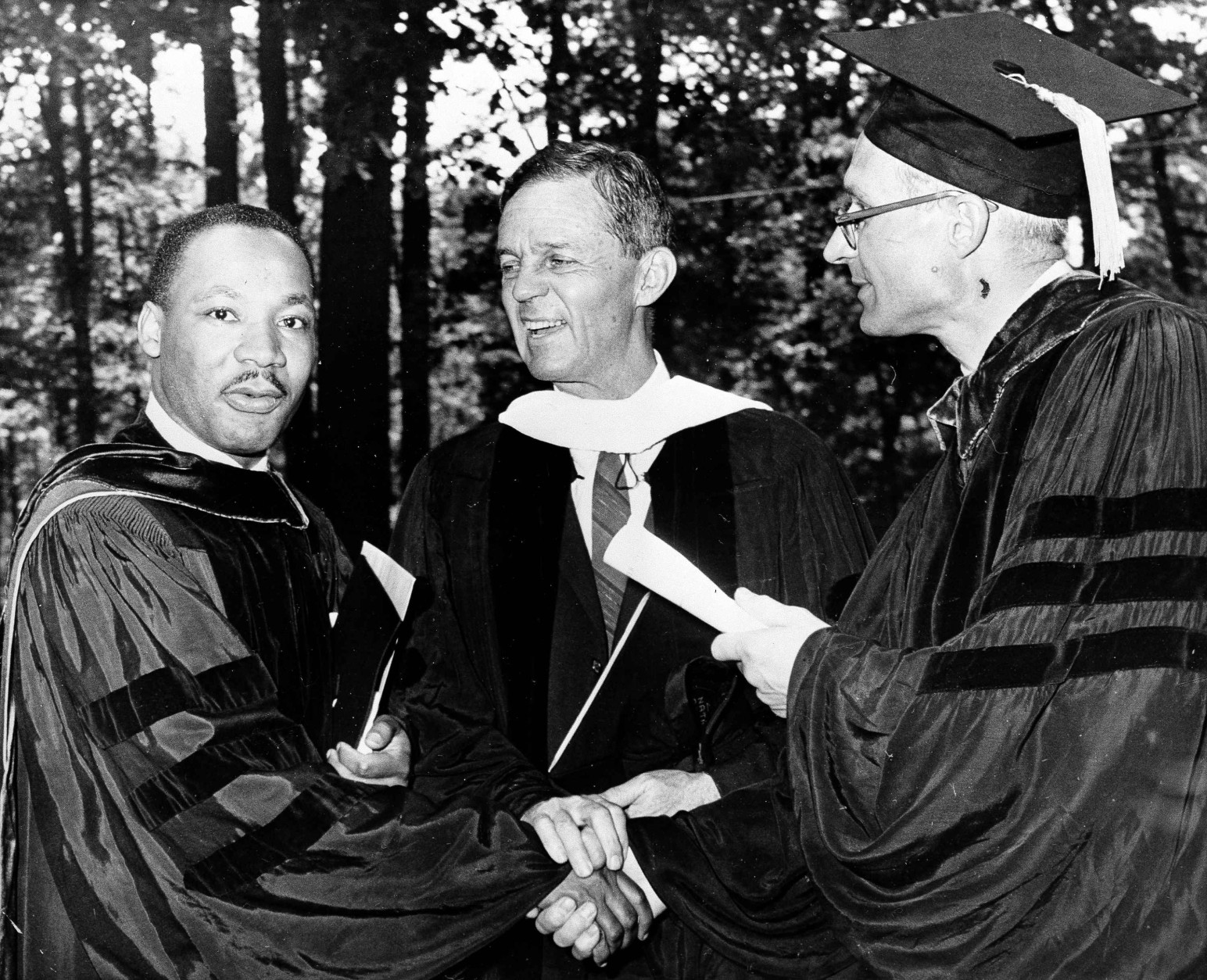 U.S. Sen. Joseph Clark (D-Pa.), center, laughs along with Dr. Martin Luther King, left, leader against segregation, at Lincoln University commencement exercises, June 7, 1961, Oxford, Pa. At right is acting President Donald Yelton. (AP Photo/Sam Myers)