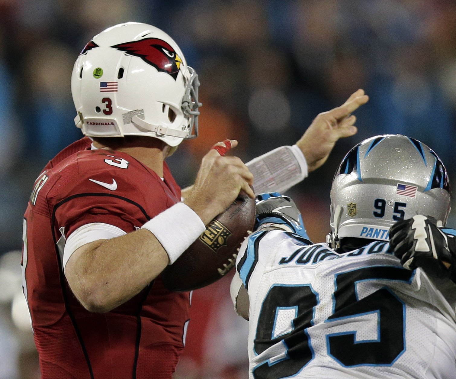 Carolina Panthers' Charles Johnson knocks the ball away from Arizona Cardinals' Carson Palmer during the first half the NFL football NFC Championship game Sunday, Jan. 24, 2016, in Charlotte, N.C. The Panthers recovered the ball. (AP Photo/Chuck Burton)