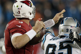 Carolina Panthers' Charles Johnson knocks the ball away from Arizona Cardinals' Carson Palmer during the first half the NFL football NFC Championship game Sunday, Jan. 24, 2016, in Charlotte, N.C. The Panthers recovered the ball. (AP Photo/Chuck Burton)