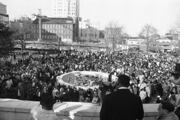 Dr. Martin Luther King Jr., President of the Southern Christian Leadership Conference, is heavily guarded as he speaks to an estimated crowd of 2,500 who braved freezing weather to attend an anti-segregation rally in downtown Hurt Park in Atlanta Sunday, Dec. 16, 1963. Police said the integration leaders life had not been threatened, but the officers were a precautionary measure. (AP Photo/Horace Cort)