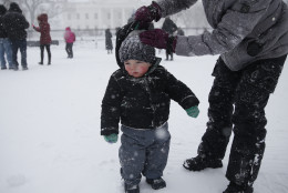 Meghan Murphy of Crofton, Md., adjusts the hat of her son Chase Murphy,  1, during heavy snowfall in front of the White House in Washington on Saturday, Jan. 23, 2016.  A blizzard with hurricane-force winds brought much of the East Coast to a standstill Saturday, dumping as much as 3 feet of snow, stranding tens of thousands of travelers and shutting down the nation's capital and its largest city.(AP Photo/Gerald Herbert)