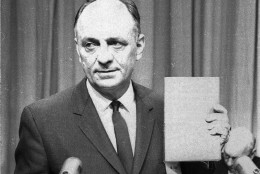 U.S. Surgeon General Luther Terry holds a copy of the 387 page report of the Advisory Committe to the Surgeon General of the Public Health Service on the relationsship of smoking to health Jan. 11, 1964.  He spoke at a Washington news conference at which the study was released.  It termed smoking a health hazard calling for corrective action. (AP Photo/hwg)