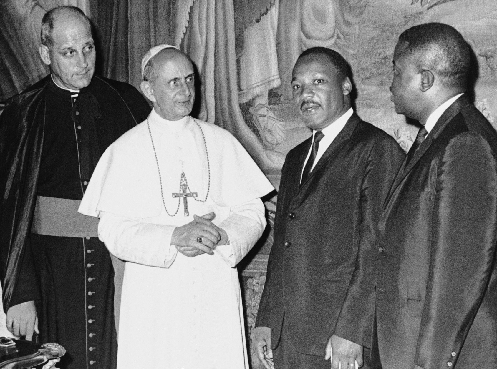 In his photo released by the Vatican, Pope Paul VI poses at the Vatican with American civil rights leader Dr. Martin Luther King, Jr., during a private audience, Sept. 18, 1964.  With the pontiff and King are Msgr. Paolo Marcinkus of Chicago, who acted as interpreter, and with King is his aide, Dr. Ralph Abernathy, right. (AP Photo/Vatican Photo)