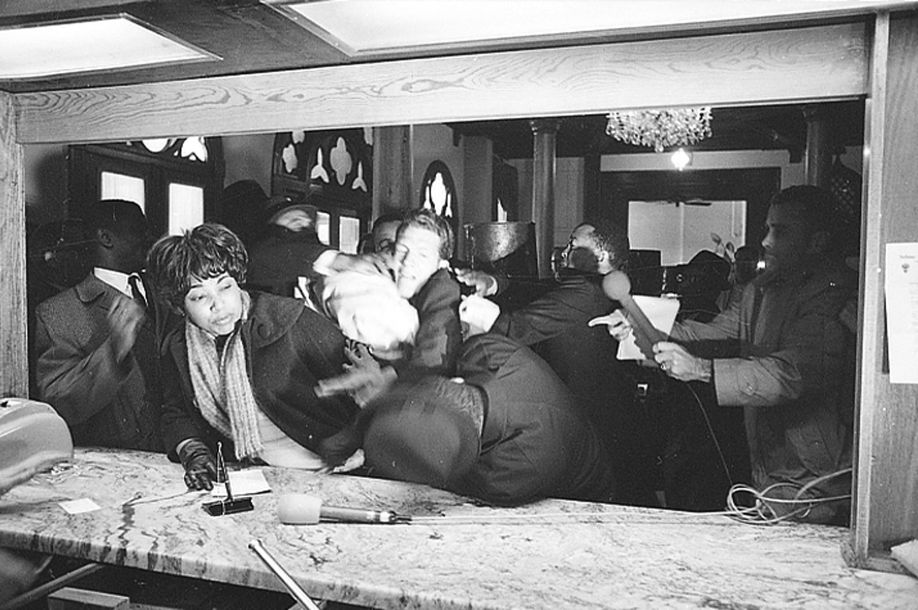 Civil rights leader Dr. Martin Luther King Jr. is attacked by States Rights Party member Jimmy Robinson as King tries to register at the Hotel Albert in Selma, Ala., Jan. 18, 1965.  The woman at left is trying to avoid the altercation.  King was not injured.  (AP Photo/Horace Cort)