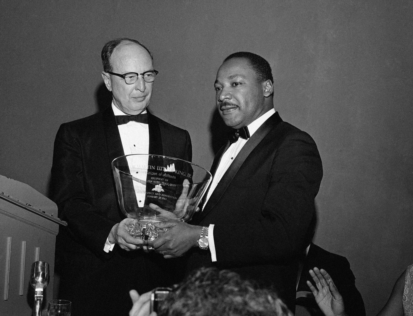 Civil rights leader Dr. Martin Luther King Jr., right, winner of the 1964 Nobel Peace Prize, receives a glass bowl inscribed to him as a "Citizen of Atlanta, with respect and admiration," from Rabbi Jacob Rothschild of the Temple Synagogue in Atlanta, Jan. 28, 1965. The award was presented at a banquet sponsored by Atlanta citizens in honor of King's receiving the Nobel Prize. (AP Photo)