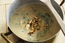 This Sept. 14, 2015 photo shows roasted cauliflower and greens soup with cheesy rye toasts in Concord, NH. The finished product is a tasty, hearty, healthy and affordable soup for supper. And if you use vegetable broth, its vegetarian, too. (AP Photo/Matthew Mead)