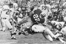 The Packers' Klijah Pitts (22) goes over right tackle to the Chiefs' five-yard line, a six-yard gain, before being brought down by Kansas City's Johnny Robinson in the fourth quarter of the Super Bowl game in Los Angeles Jan. 15, 1967.  Three plays later Pitts went over for the touchdown as the Packers beat the Chiefs 35 to 10.  Others include Bobby Hunt (20) and Sherrill Headrick (69).  (AP Photo)