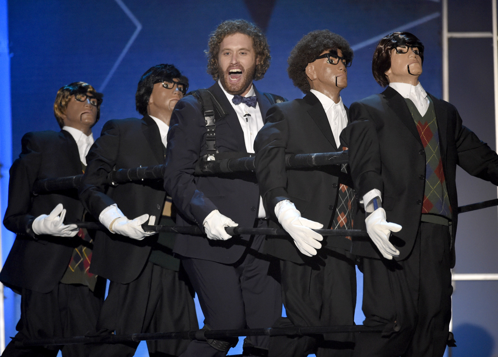 Host T.J. Miller, center, performs on stage at the 21st annual Critics' Choice Awards at the Barker Hangar on Sunday, Jan. 17, 2016, in Santa Monica, Calif. (Photo by Chris Pizzello/Invision/AP)