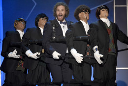 Host T.J. Miller, center, performs on stage at the 21st annual Critics' Choice Awards at the Barker Hangar on Sunday, Jan. 17, 2016, in Santa Monica, Calif. (Photo by Chris Pizzello/Invision/AP)