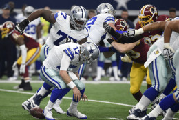 Dallas Cowboys quarterback Kellen Moore (17) fumbles the snap as the Washington Redskins rush in the first half of an NFL football game, Sunday, Jan. 3, 2016, in Arlington, Texas. The Redskins recovered the fumble. (AP Photo/Michael Ainsworth)