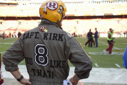 Washington Redskins fan Tim Kline watches the team warm up before an NFL wild card playoff football game against the Green Bay Packers in Landover, Md., Sunday, Jan. 10, 2016. (AP Photo/Nick Wass)