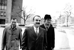 Three of the seven defendents, including G. Gordon Liddy, center, charged in connection with the break-in and alleged bugging of Democratic headquarters arrive at U.S. District Court for the start of their trial on Jan. 8, 1973. Others are unidentified. (AP Photo)