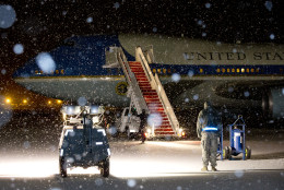 As snow falls, Air Force One sits on the tarmac, Wednesday, Jan. 20, 2016, in Andrews Air Force Base, Md., after President Barack Obama left in a motorcade en route to Washington after a trip to Detroit.  While in Detroit the President visited the 2016 North American International Auto Show and spoke about the progress made by the city, its people and neighborhoods, and the American auto industry. (AP Photo/Carolyn Kaster)