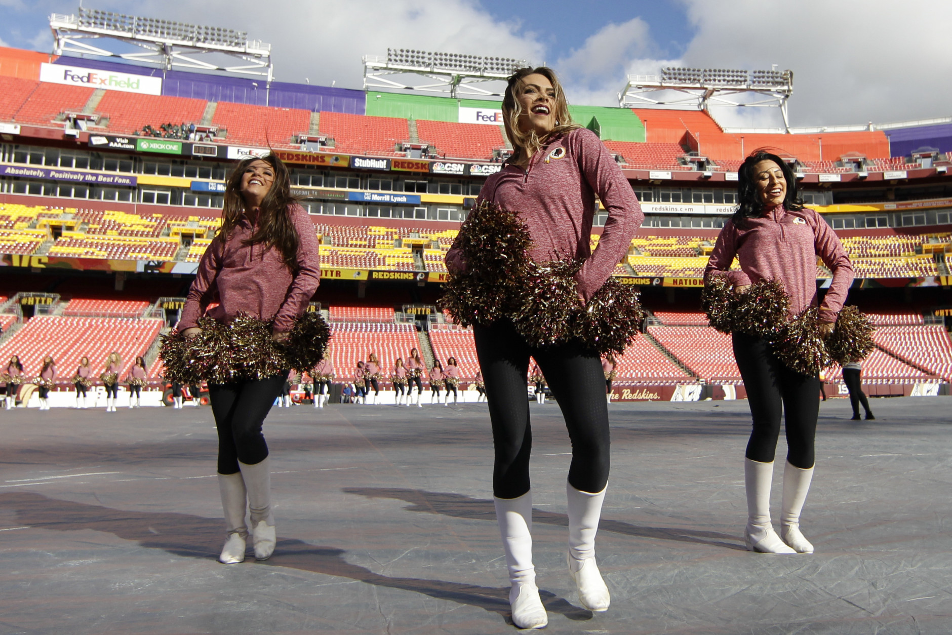 The Washington Redskins cheerleaders warm up before an NFL football game against the Green Bay Packers in Landover, Md., Sunday, Jan. 10, 2016. (AP Photo/Mark Tenally)