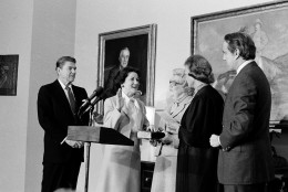 Supreme Court Justice Sandra Day O'Connor swears in Elizabeth Dole as the new Transportation Secretary, as President Reagan looks on at left, in an East Room ceremony at the White House, Feb. 7, 1983.  At far right is the husband of the secretary, Sen. Robert Dole, R-Kan., and at center is her mother, Mary Hanford.  (AP Photo)